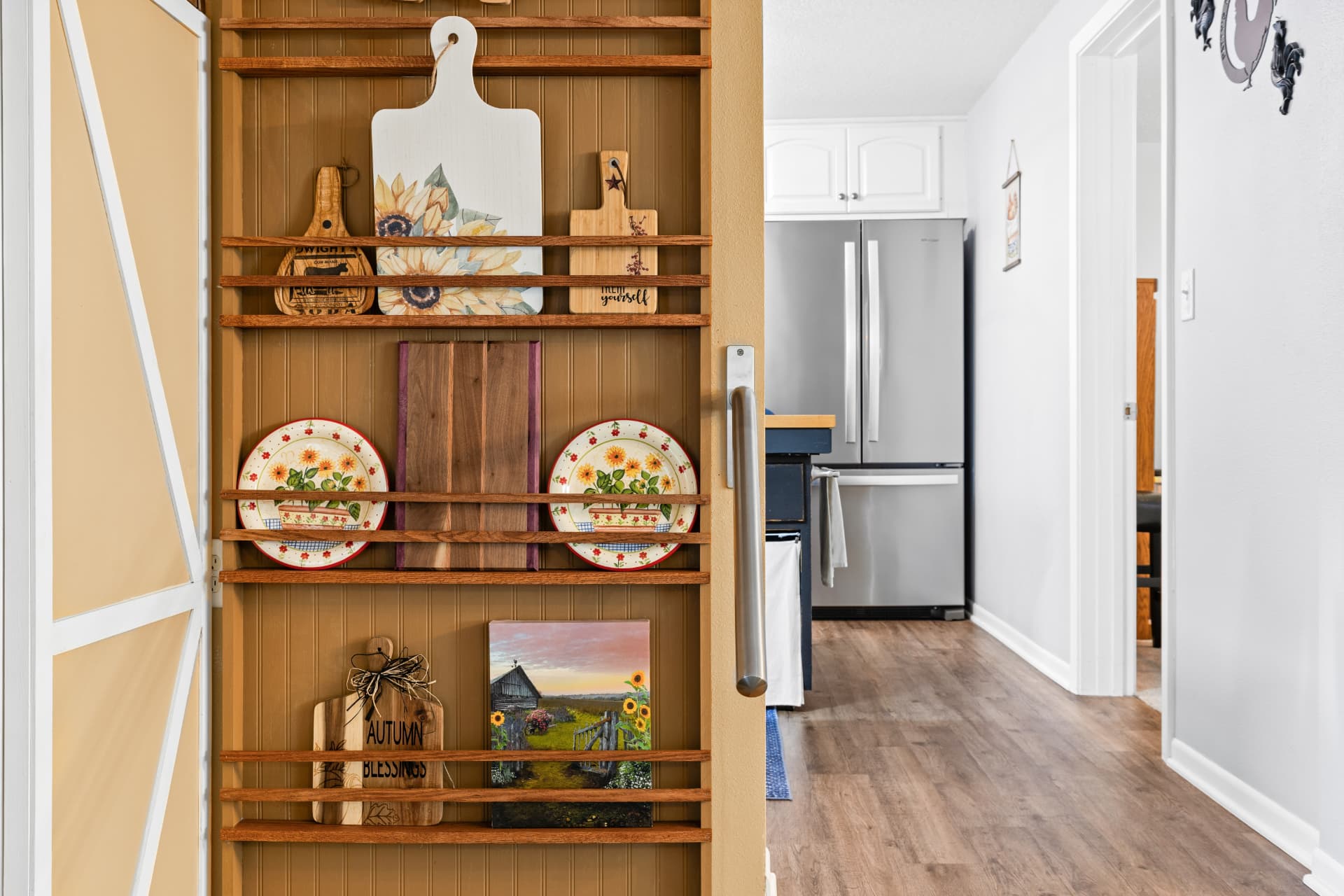 Built-in wood display shelving beside the barn door and hallway