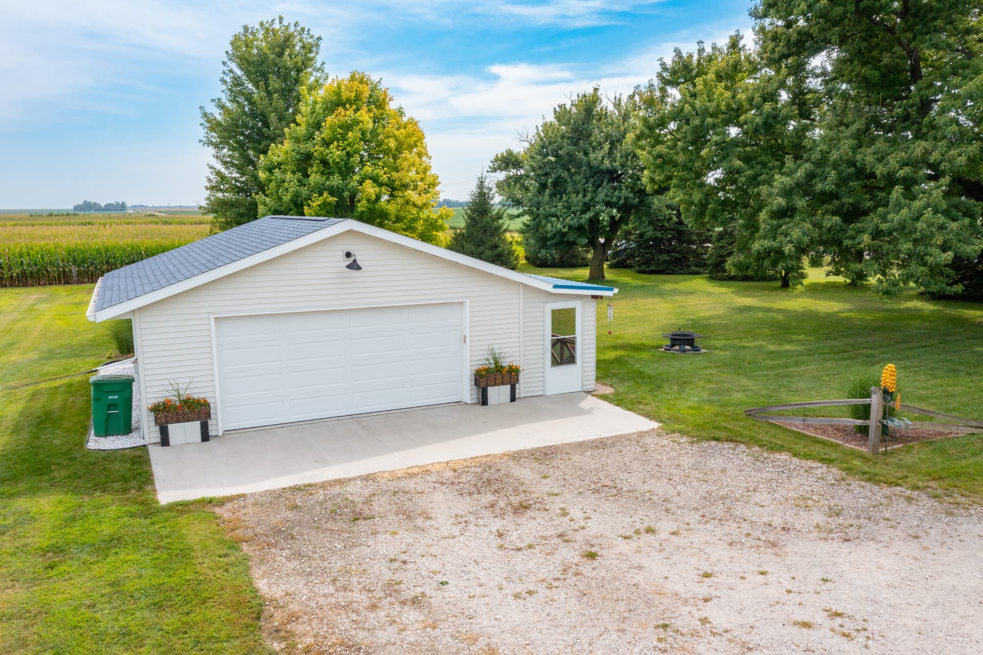 Front of the new 22x24 detached garage with concrete apron and corn field beyond