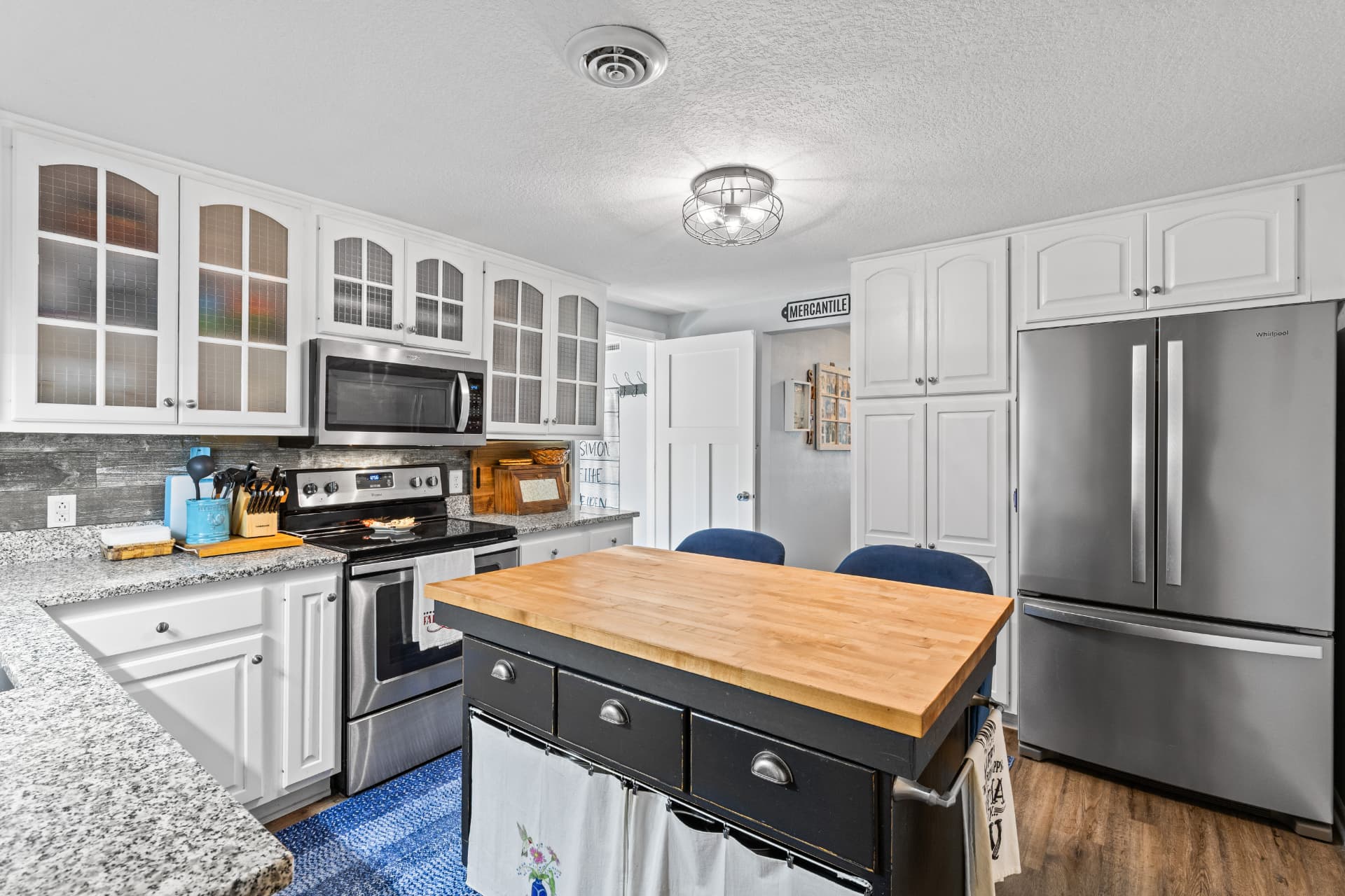 Kitchen with stainless steel appliances and pantry cabinets